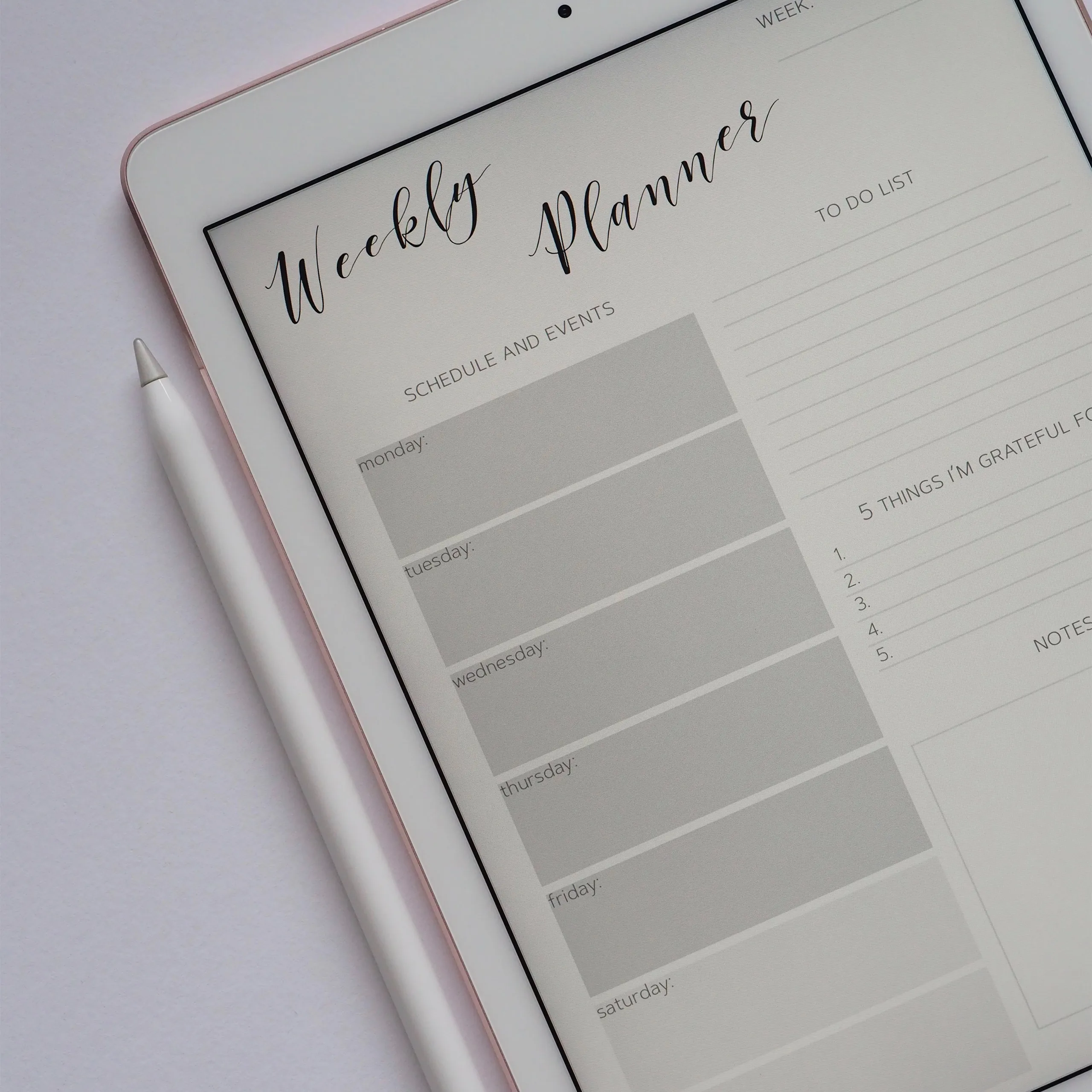 iPad displaying a digital weekly planner on screen