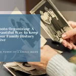 Older Adult Holding Vintage Photos – Your Photo Assistant Hands of an older adult holding two vintage photos with more photos on a table beside reading glasses
